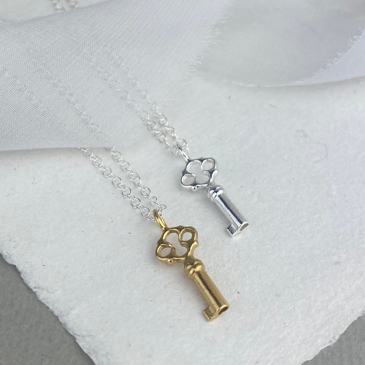 The Lock Charm necklace- sterling silver and 22ct gold vermeil charms on a trace chain necklace