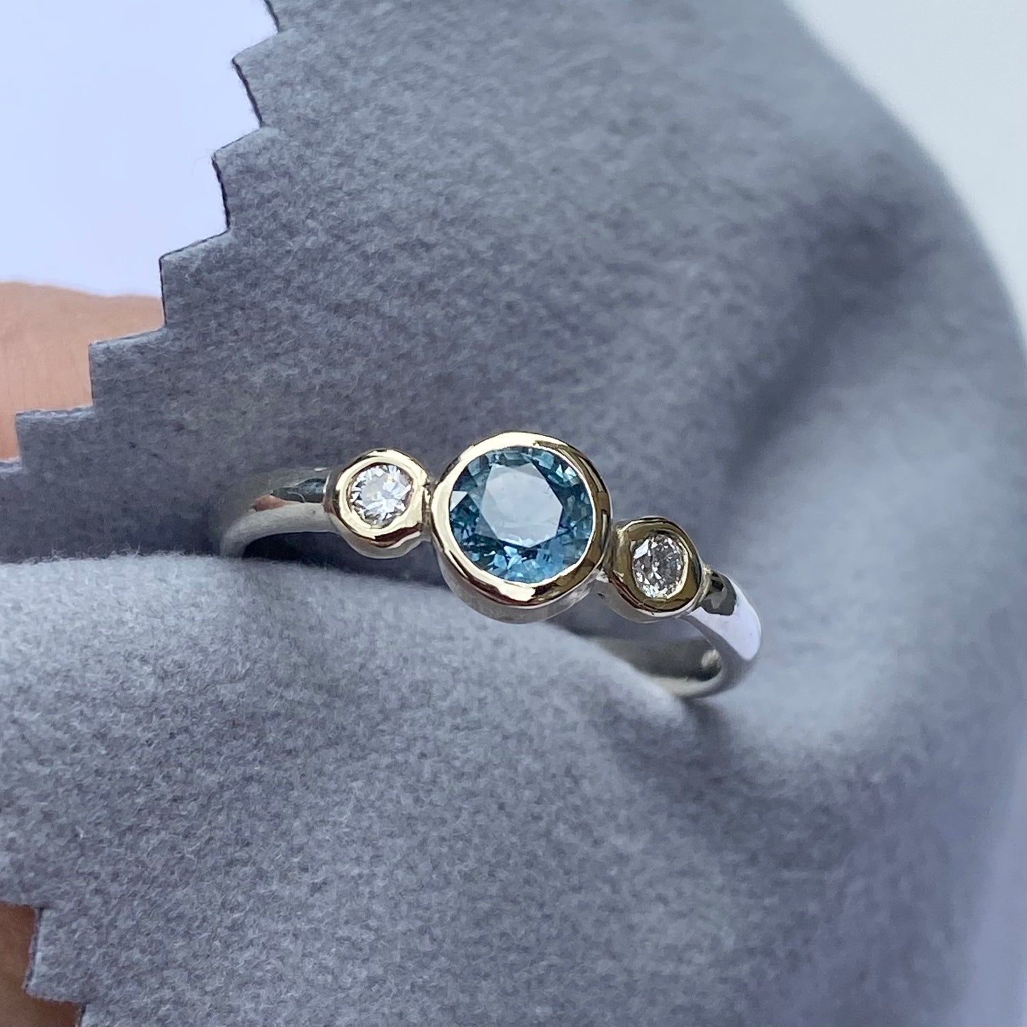 Teal sapphire and diamond ring set in yellow and white gold
