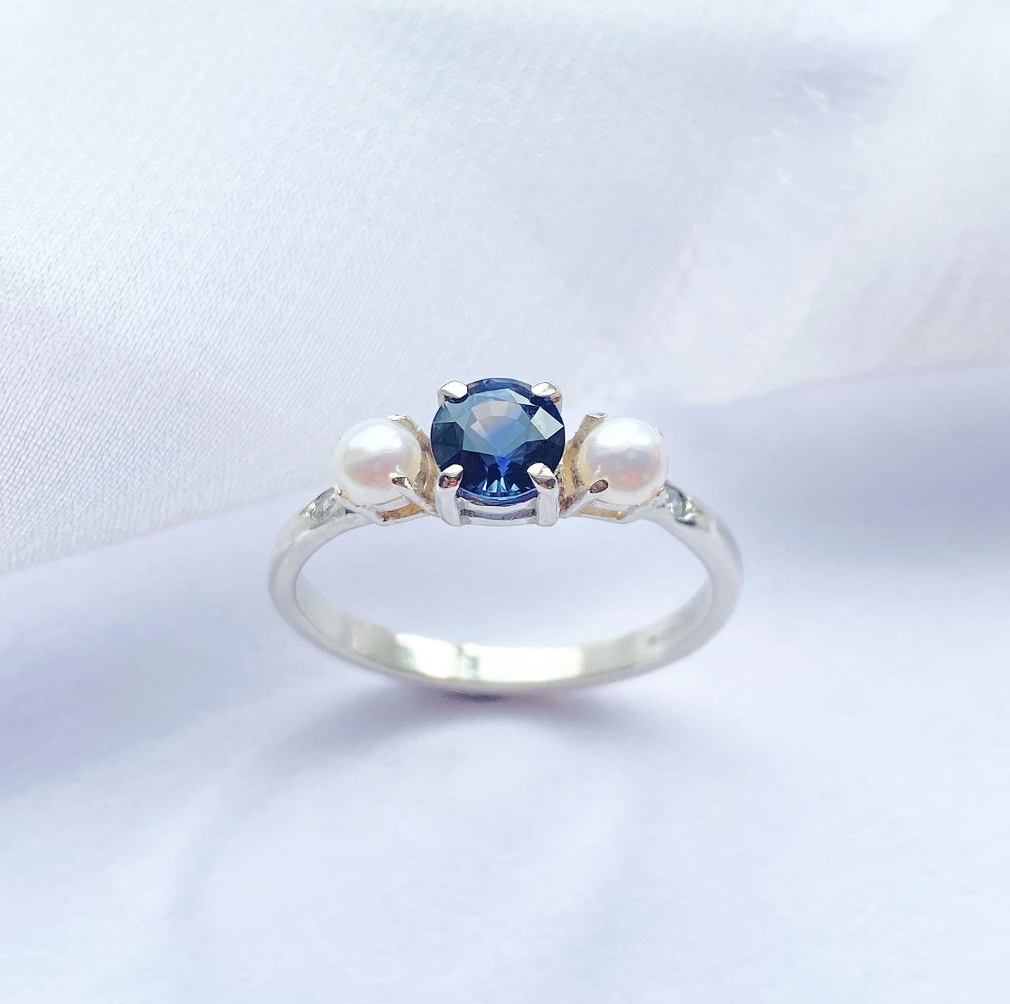 White Gold Eternity Ring Set with a sapphire and two pearls