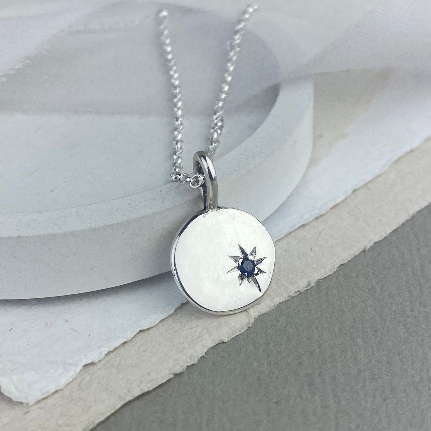 Silver pendant with star set sapphire