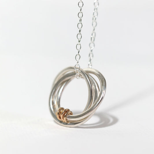 Silver necklace with a unique pendant on a white background