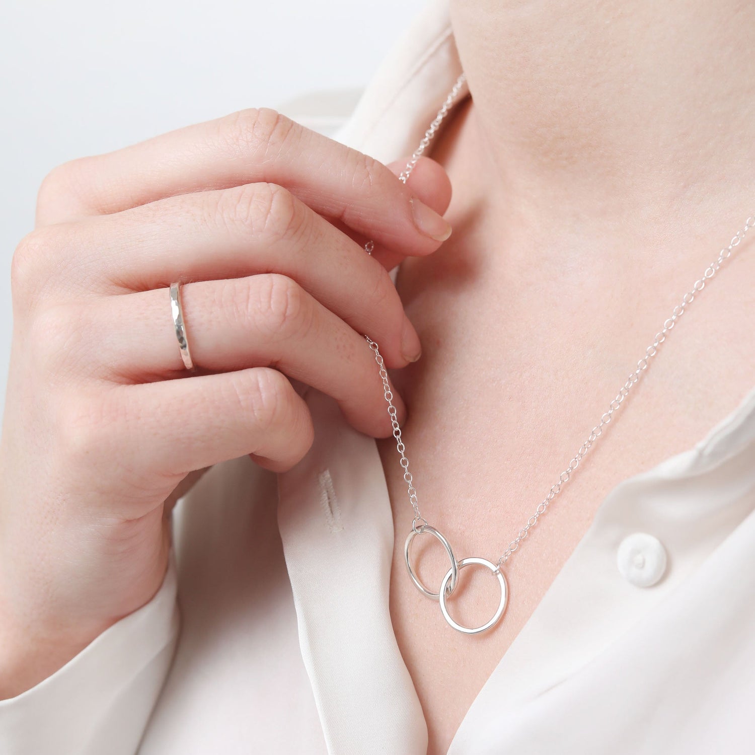 Personalised silver necklace and ring being modelled 